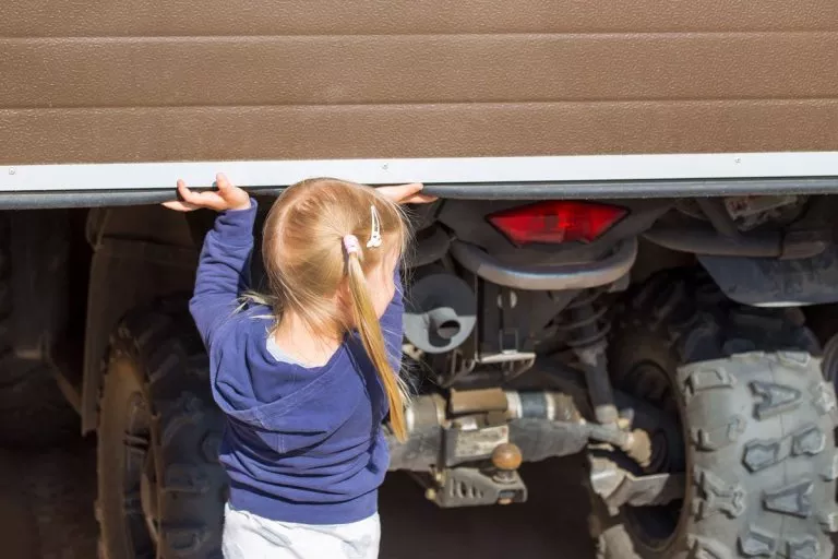 Child under a garage door